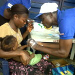 IMG00045-20111111-1154 CHW testing child for malaria